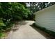 Spacious driveway leading to the home's side entrance and garage, surrounded by trees at 4113 Oak Park Rd, Raleigh, NC 27612