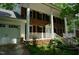 Attractive brick home with a white front porch, complemented by a spacious three-car garage at 4113 Oak Park Rd, Raleigh, NC 27612