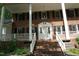 Close-up view of the home's front entrance with a white door and brick steps at 4113 Oak Park Rd, Raleigh, NC 27612