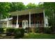 Beautiful brick home with a white-columned porch, shutters, and a well-manicured front yard at 4113 Oak Park Rd, Raleigh, NC 27612