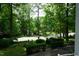View from the front porch overlooking the manicured front yard and tree-lined street at 4113 Oak Park Rd, Raleigh, NC 27612