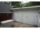 Side of garage featuring both double wide and single door on the side of this brick and siding home at 4113 Oak Park Rd, Raleigh, NC 27612
