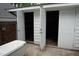 Side of garage with double doors and single door open, exposing storage space on the side of the house at 4113 Oak Park Rd, Raleigh, NC 27612
