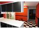 Spacious kitchen with black cabinets, white countertops, and striking black-and-white checkered floors at 4113 Oak Park Rd, Raleigh, NC 27612