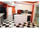 Bright, unique kitchen with black and white checkered flooring and island workstation at 4113 Oak Park Rd, Raleigh, NC 27612