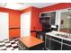The updated kitchen features an island and sleek black appliances, plus bright red paint at 4113 Oak Park Rd, Raleigh, NC 27612