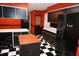 Kitchen offers black appliances, an island, checkered flooring, and red painted walls at 4113 Oak Park Rd, Raleigh, NC 27612