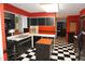View of the kitchen showcasing checkered flooring, island, and black appliances at 4113 Oak Park Rd, Raleigh, NC 27612