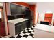 Kitchen features black appliances and checkered flooring, offering a unique look at 4113 Oak Park Rd, Raleigh, NC 27612