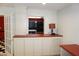Open kitchenette area with black appliances, a red countertop, and white cabinets at 4113 Oak Park Rd, Raleigh, NC 27612