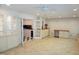 Spacious living room with built-in shelving and storage cabinets, a ceiling fan, and access to a kitchen at 4113 Oak Park Rd, Raleigh, NC 27612