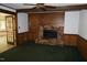 Gathering room features a brick fireplace, wood paneling, and built-in cabinets at 4113 Oak Park Rd, Raleigh, NC 27612