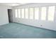 Bright living room featuring multiple windows, neutral paint, and carpeted floor at 4113 Oak Park Rd, Raleigh, NC 27612
