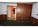 Spacious room featuring built in bookshelf, and open door to the kitchen at 4113 Oak Park Rd, Raleigh, NC 27612