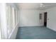 Bright living room features a ceiling fan, carpeted floor and natural light from the windows at 4113 Oak Park Rd, Raleigh, NC 27612