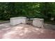 Outdoor kitchen features stone countertops and a stainless steel grill on brick patio at 4113 Oak Park Rd, Raleigh, NC 27612