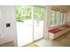 Bright sunroom with tan tile flooring and a large sliding glass door leading to the outdoor patio at 4113 Oak Park Rd, Raleigh, NC 27612