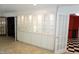 Sunroom with display cabinets along the wall, doors leading to other rooms, and a tiled floor at 4113 Oak Park Rd, Raleigh, NC 27612