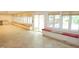 Sunroom with large windows, built-in seating, and tile flooring that provides plenty of natural light and comfort at 4113 Oak Park Rd, Raleigh, NC 27612