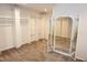 Large walk-in closet with a full-length mirror, built-in shelves, and hanging racks at 4113 Oak Park Rd, Raleigh, NC 27612