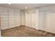 Walk-in closet with carpet and white shelving and bars for optimal storage space at 4113 Oak Park Rd, Raleigh, NC 27612