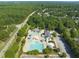 Aerial view of the community pool, surrounded by trees and a parking area at 420 Marsh Landing Dr, Holly Springs, NC 27540