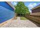 The backyard features a stone patio, a walkway, and wooden fencing at 420 Marsh Landing Dr, Holly Springs, NC 27540