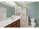 Bathroom features a single sink vanity, glass shower, and neutral tile at 420 Marsh Landing Dr, Holly Springs, NC 27540