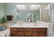 Bathroom with a double sink vanity, large mirror, and neutral tile at 420 Marsh Landing Dr, Holly Springs, NC 27540