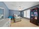 bedroom with blue walls, white trim, and window overlooking the backyard at 420 Marsh Landing Dr, Holly Springs, NC 27540