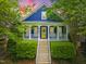 Charming two-story blue home with a welcoming yellow front door and porch at 420 Marsh Landing Dr, Holly Springs, NC 27540