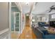 Inviting hallway with hardwood floors, staircase, and a glimpse of the living room at 420 Marsh Landing Dr, Holly Springs, NC 27540