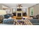 Spacious living room featuring a fireplace, TV, natural light, and comfortable seating arrangements at 420 Marsh Landing Dr, Holly Springs, NC 27540