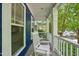 Inviting front porch with white rocking chairs and railings, offering a cozy outdoor seating area with views of the neighborhood at 420 Marsh Landing Dr, Holly Springs, NC 27540