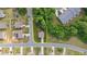 Aerial view showcasing the home's location on a corner lot, surrounded by mature trees and neighborhood streets at 4221 Northrop Dr, Haw River, NC 27258