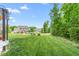 Expansive backyard with a fire pit, seating, and lush grass, ideal for outdoor activities and entertaining at 4221 Northrop Dr, Haw River, NC 27258