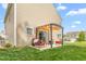 Backyard featuring a covered patio with comfortable seating, set on a well-manicured lawn, perfect for gatherings at 4221 Northrop Dr, Haw River, NC 27258
