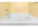 Bright bathroom showing the white drop in soaking tub and yellow walls at 4221 Northrop Dr, Haw River, NC 27258