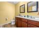Bathroom featuring a double sink vanity with a dark wood finish and framed mirrors at 4221 Northrop Dr, Haw River, NC 27258