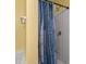 Bathroom shower stall with a blue patterned shower curtain and yellow walls at 4221 Northrop Dr, Haw River, NC 27258