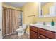 Bright bathroom featuring a vanity, toilet, and shower with curtain, offering comfort and convenience at 4221 Northrop Dr, Haw River, NC 27258