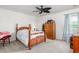 Cozy bedroom featuring a four-poster bed, patterned carpet, and neutral wall color at 4221 Northrop Dr, Haw River, NC 27258