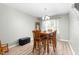 Bright dining room features a modern chandelier, a table with seating for six, and hardwood floors at 4221 Northrop Dr, Haw River, NC 27258