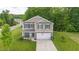 Inviting two-story home featuring charming details, landscaped front yard, and attached garage at 4221 Northrop Dr, Haw River, NC 27258