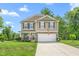 Charming two-story home with stone accents, manicured lawn, and attached two-car garage at 4221 Northrop Dr, Haw River, NC 27258