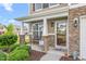 Inviting front porch with stone pillars, bench, and decorative welcome sign, creating a cozy entrance at 4221 Northrop Dr, Haw River, NC 27258