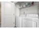 Practical laundry area with a white washer and dryer, complemented by shelving for storage at 4221 Northrop Dr, Haw River, NC 27258