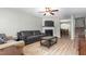 Cozy living room with fireplace, ceiling fan, hardwood floors, and an open view to the dining area at 4221 Northrop Dr, Haw River, NC 27258