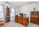 Home office featuring a large wooden desk, shelving, and carpeted floors at 4221 Northrop Dr, Haw River, NC 27258