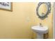 Charming powder room boasting a pedestal sink and decorative mirror, adding elegance to functionality at 4221 Northrop Dr, Haw River, NC 27258
